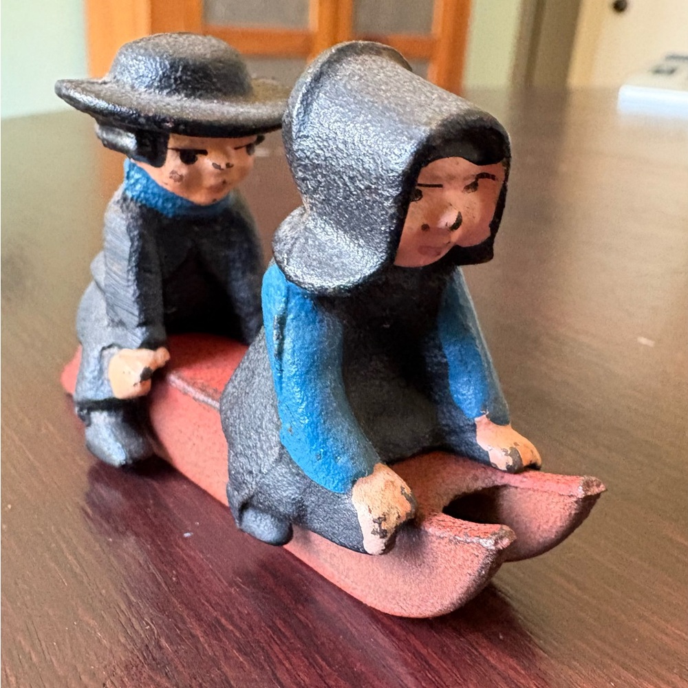 Vintage Cast Iron Amish Couple Sledding Figurines